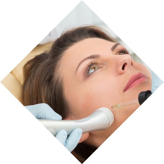 Woman lying down having a laser facial treatment